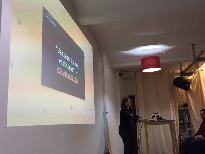 Sara up front. On the projector is a slide with Charlie’s quote.