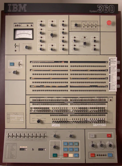 The control panel for the IBM System/360 Model 50 had numerous lights, knobs and toggle switches, along with a voltmeter.