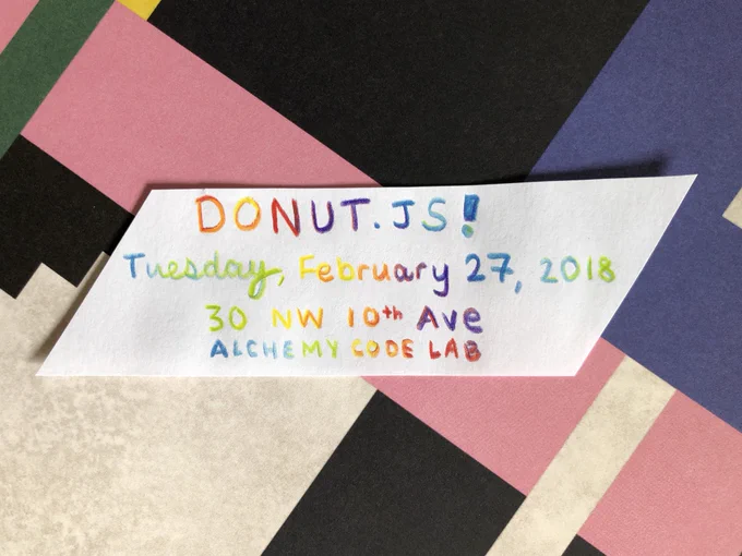 A piece of paper on a colorful patterned background that reads “DONUT.JS. Tuesday, February 27. 30 NW 10th Ave - Alchemy Code Lab”