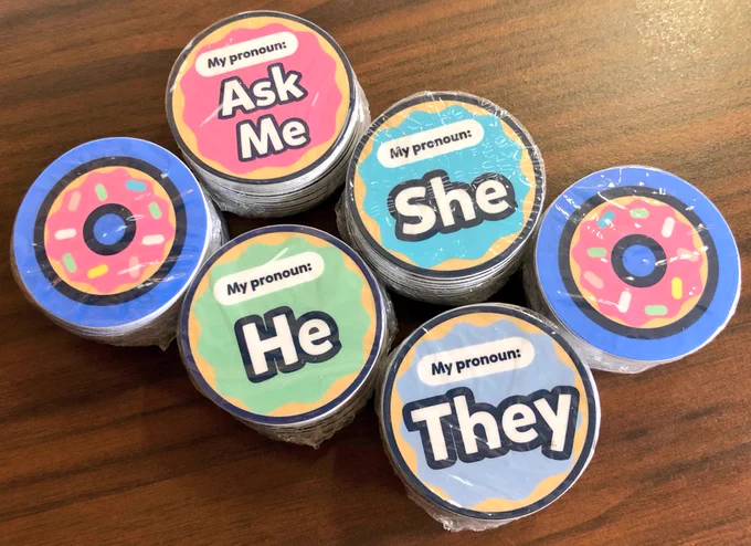 Six packs of newly printed stickers: 2 of the donutjs logo and 4 pronoun stickers (‘ask me,’ ‘he,’ ‘she,’ ‘they’)