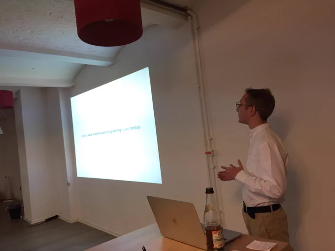 Łukasz showing an example of a button on stage.