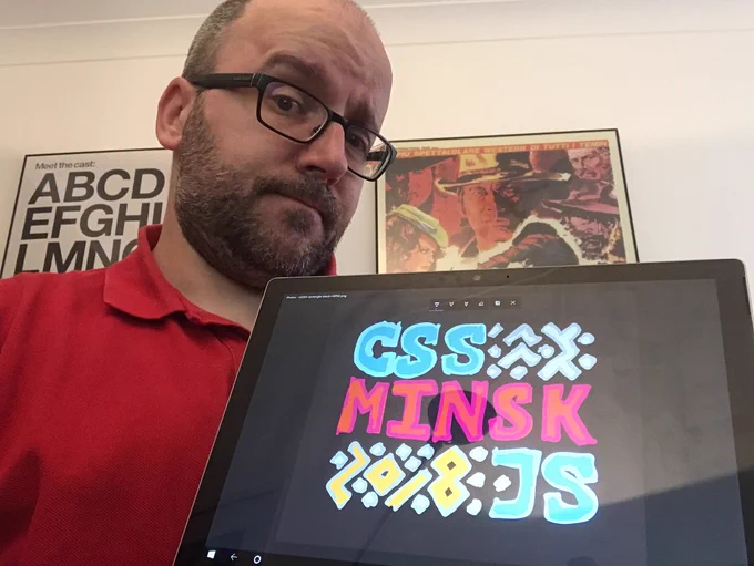 me, with my surface pro in tablet mode, showing a hand-retraced version of the CSS Minsk JS 2018 logo