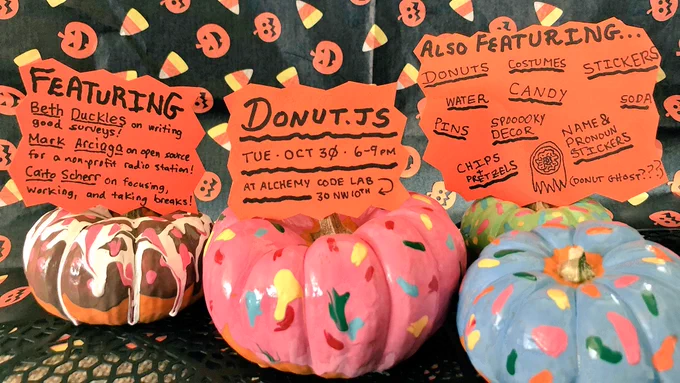 Pumpkins painted like donuts. Pieces of paper resting atop pumpkins: “Donut.js; Tue, Oct 30 6-9pm; At Alchemy Code Lab (30 NW 10th Ave)” and “Featuring: Beth Duckles on writing good surveys, Mark Arciaga on open source software for a non-profit radio station, Caito Scherr on focusing, working, and taking breaks” and “Featuring donuts, costumes, candy, pins, stickers, spooky decor, pronoun stickers, soda, water.”