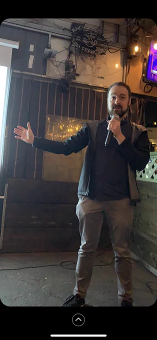 Photo of Max with a microphone