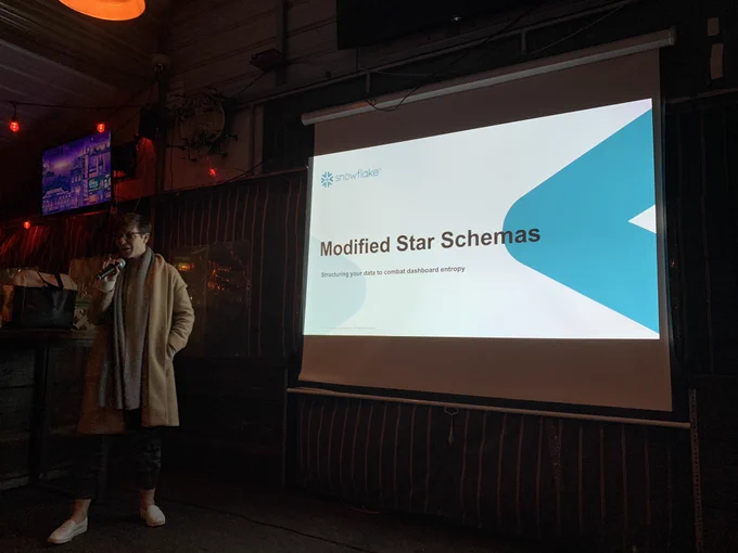Photo of her in front of a title slide