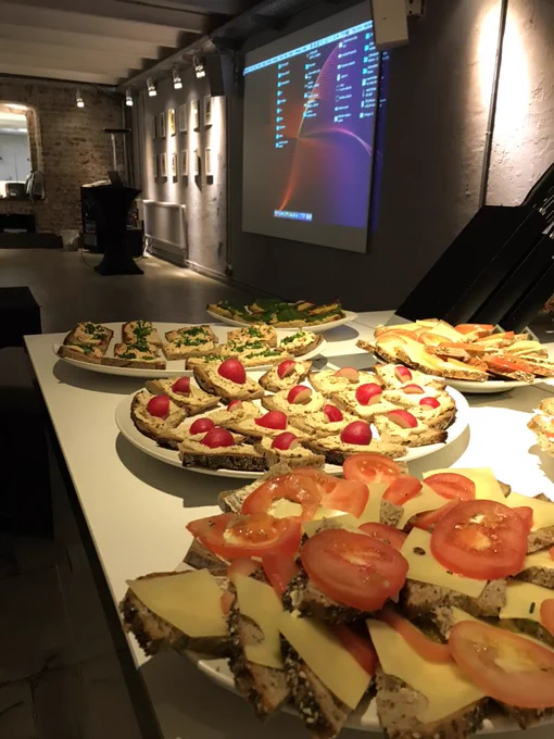 Plates of bread with toppings on a table.