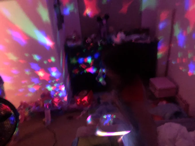 Photo of a room with stars that’s blurry and dark