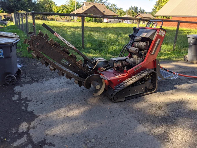 Trencher pulled conduit to beginning  of road