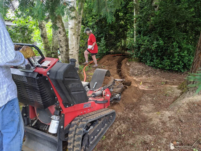 Trenching through our "woods" to our house.