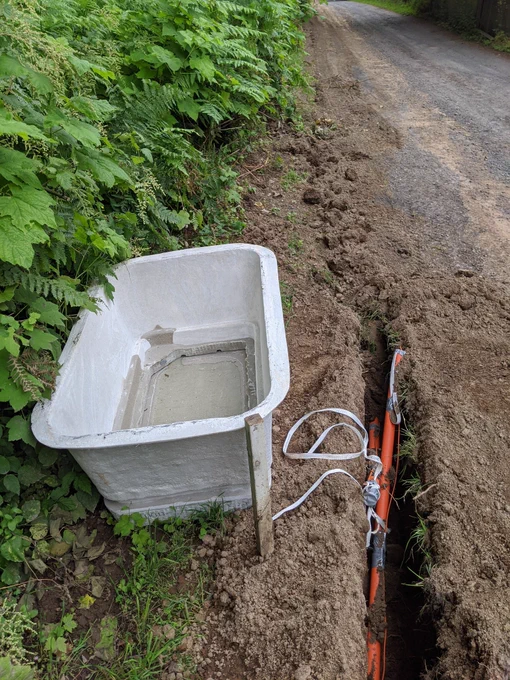 An upside-down concrete vault needs to be buried flush to the ground.