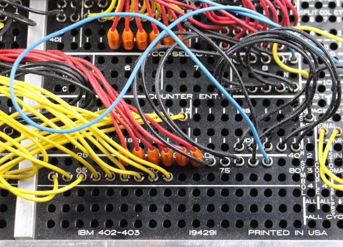 Closeup of the plugboard showing how wires plug into holes. Labeled "IBM 402-403".
