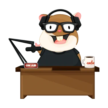 Tomster, one of the Ember mascots, sits behind a desk with headphones and a microphone, ready to teach people about Ember.js