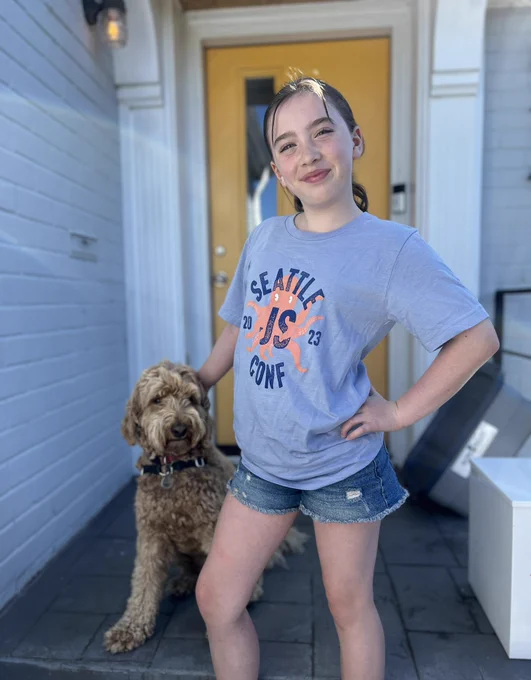 Emily modeling her XS SeattleJS Conf t-shirt with her dog Otto.