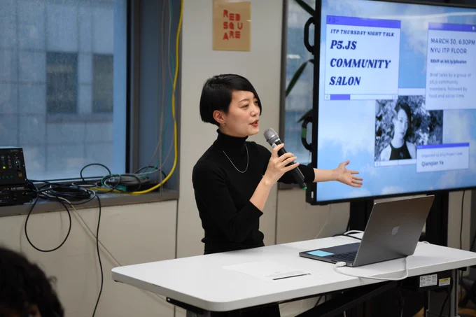 An image of Qianqian Ye holding a mic next to a big t.v. screen that has the p5.js community salon event poster on it.
