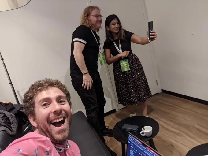Selfie I took while Anisha takes a selfie with Chris in the background
