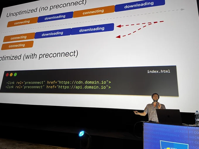 Michael presenting on stage. Behind him on screen is an example of preconnect