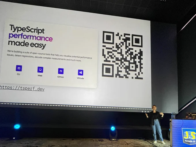 Aleksandra giving a talk at the ArmadaJS conference. The slide shows a screenshot from a tsperf landing page and a QR code that points to the website.