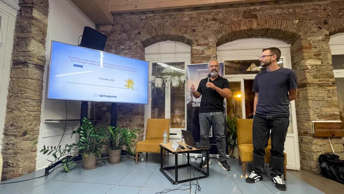 Giorgos Seriatos & Panagiotis Gkatzelidis talking about Building a large scale customer facing portal using Nuxt/VueJS technologies and an AWS based microservices architecture on the stage of GreeceJS meetup.