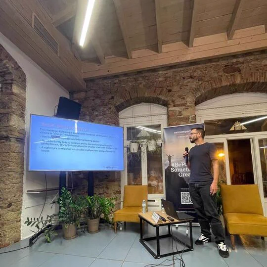 Giorgos Seriatos talking about Building a large scale customer facing portal using Nuxt/VueJS technologies and an AWS based microservices architecture on the stage of GreeceJS meetup.