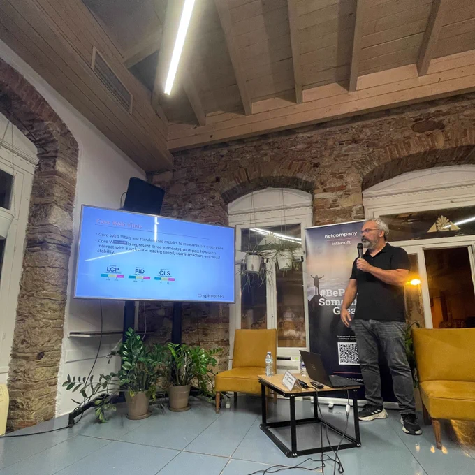Panagiotis Gkatzelidis talking about Building a large scale customer facing portal using Nuxt/VueJS technologies and an AWS based microservices architecture on the stage of GreeceJS meetup.