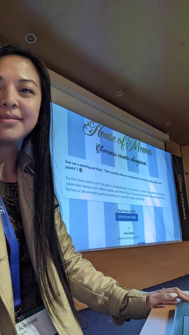 Selfie of Adrienne, her House of Memes home page behind her on the screen