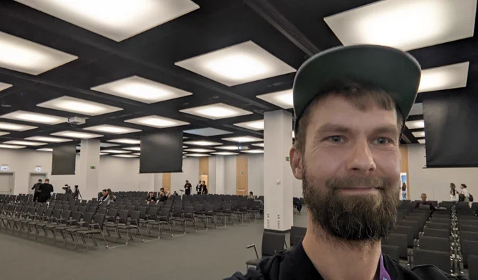 Stefan in front of an empty hall