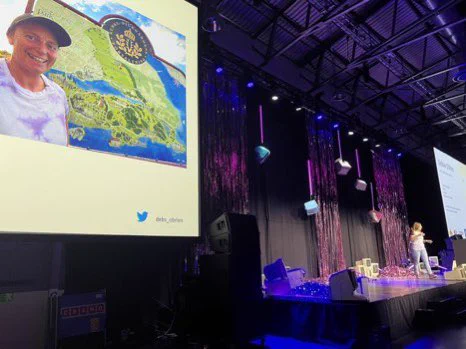 Me on stage and a photo of me on the screen