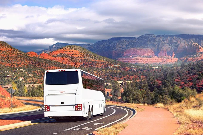 a tour bus driving through the desert 