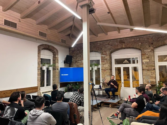 Nick Rossolatos on the stage of the GreeceJS meetup presenting Auto-saving the day: Navigating the complexities of form autosaving 