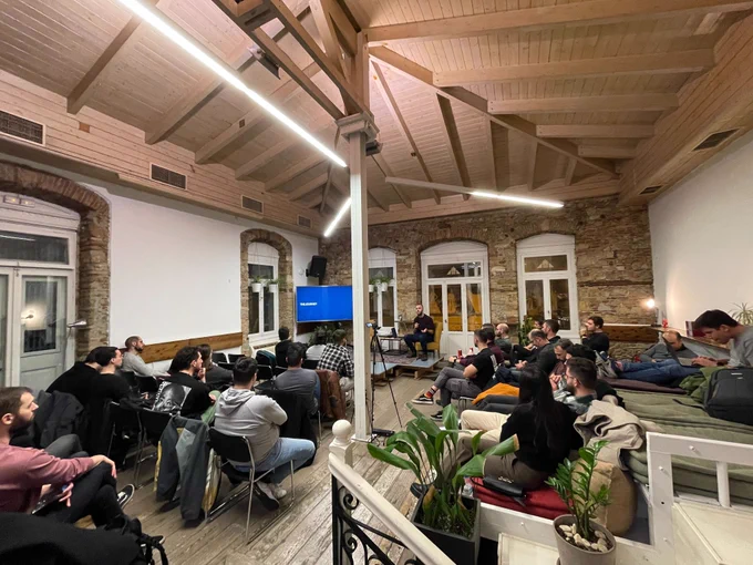 Nick Rossolatos on the stage of the GreeceJS meetup presenting Auto-saving the day: Navigating the complexities of form autosaving 