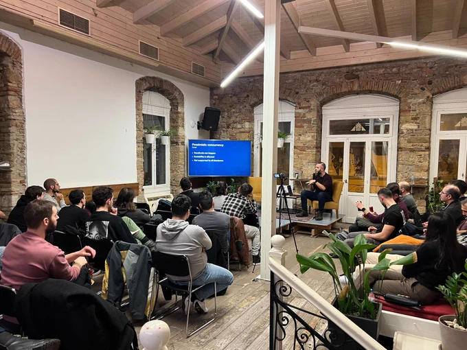 Nick Rossolatos on the stage of the GreeceJS meetup presenting Auto-saving the day: Navigating the complexities of form autosaving 