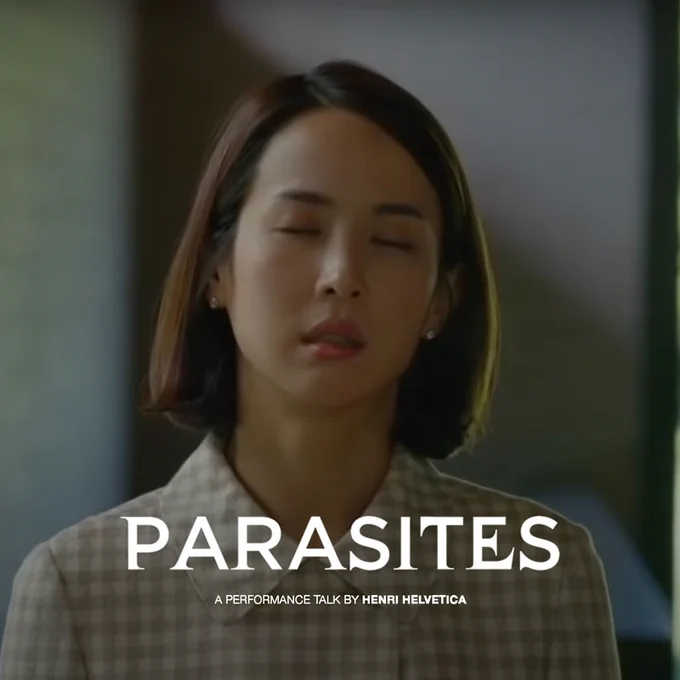 A woman with her eyes closed in near exasperation. She's wearing a gingham blouse. I caption: "parasites. A performance talk by Henri Helvetica"