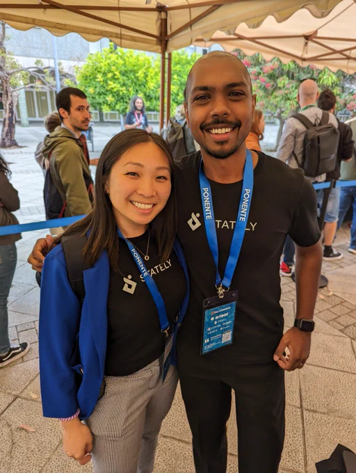 Jenny and Tejas are matching wearing black stately tee-shirts.