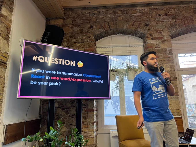Matheus Albuquerque on the stage of @greecejs #meetup presenting "Deep Diving on Concurrent #React"