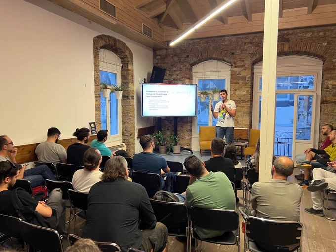 Naim Gkamperlo, Associate Director of Engineering at GWI, on the stage of @greecejs #meetup presenting "Our Journey with Micro-Frontends at GWI"