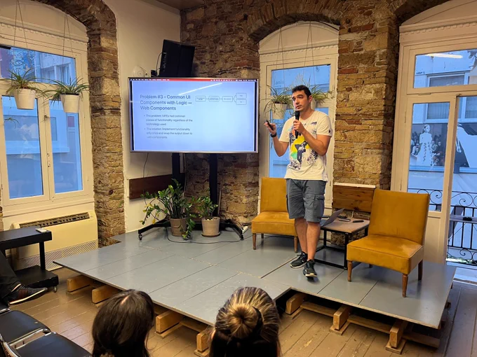 Naim Gkamperlo, Associate Director of Engineering at GWI, on the stage of @greecejs #meetup presenting "Our Journey with Micro-Frontends at GWI"