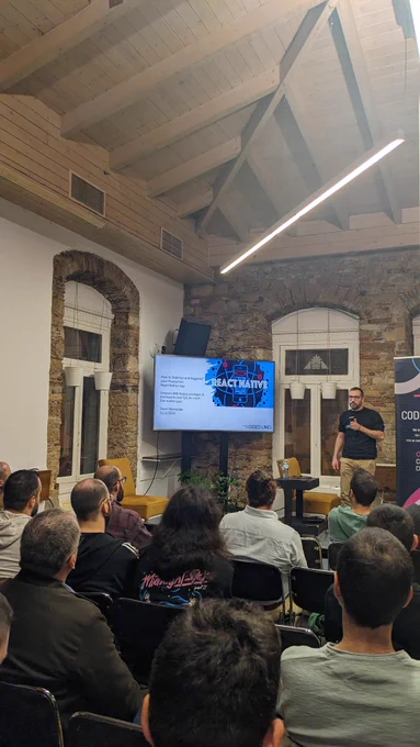 Tasos Maroudas, Technical Director at Coded Lines, talking about "How to Bugproof and Stabilize your Mobile App after Launching in Production" on the stage of GreeceJS meetup.
