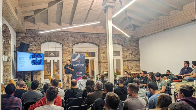 Tasos Maroudas, Technical Director at Coded Lines, talking about "How to Bugproof and Stabilize your Mobile App after Launching in Production" on the stage of GreeceJS meetup.
