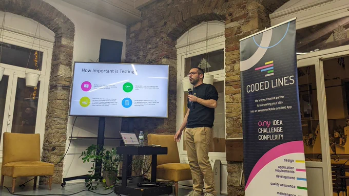 Tasos Maroudas, Technical Director at Coded Lines, talking about "How to Bugproof and Stabilize your Mobile App after Launching in Production" on the stage of GreeceJS meetup.