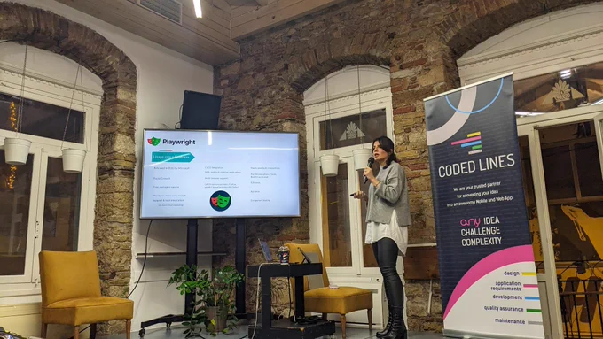 Marianna Androutsopoulou, Software Engineer in Test @ Causaly on our stage presenting "Cypress vs. Playwright: The battle of Testing Titans".