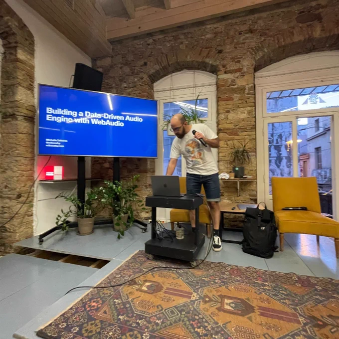 Michalis Zabaras on the stage of the 50th GreeceJS meetup.