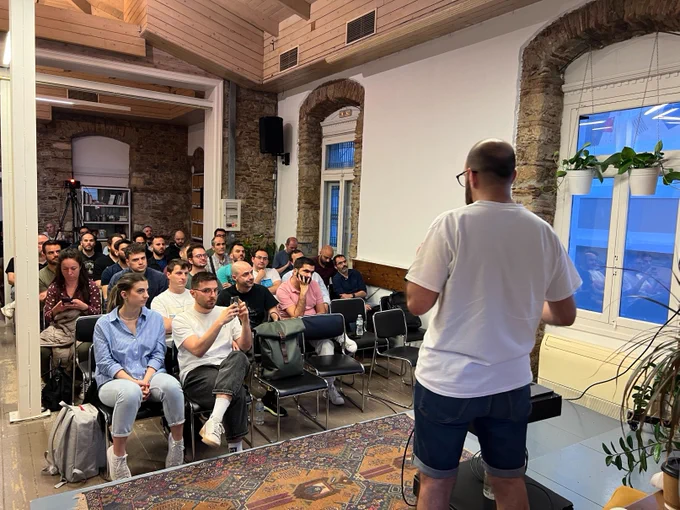 Michalis Zabaras on the stage of the 50th GreeceJS meetup.