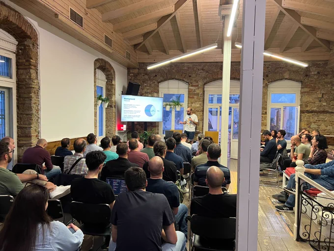Michalis Zabaras on the stage of the 50th GreeceJS meetup.