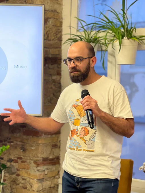 Michalis Zabaras on the stage of the 50th GreeceJS meetup.
