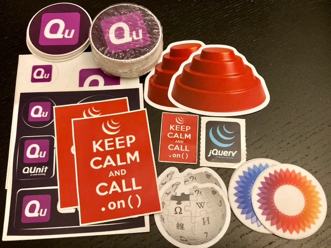 Two rolls of QUnit stickers, as well as various jQuery "Keep calm and call on()" stickers, Wikipedia stickers, and MediaWiki logo stickers.